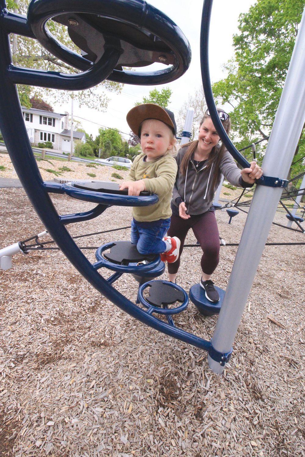 NEW HEIGHTS AT SALTER GROVE: Even at one and a half years old Lawson Sweet took to the slide in the park playground. He was intent on getting to the summit with the assistance of his mother Meghan who insisted on taking the ride down with him.